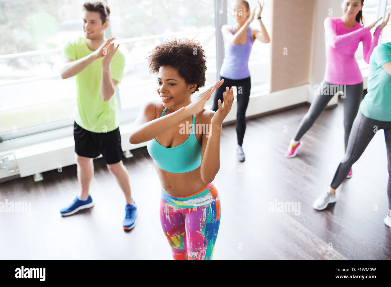 group of smiling people dancing in gym or studio Stock Photo Alamy