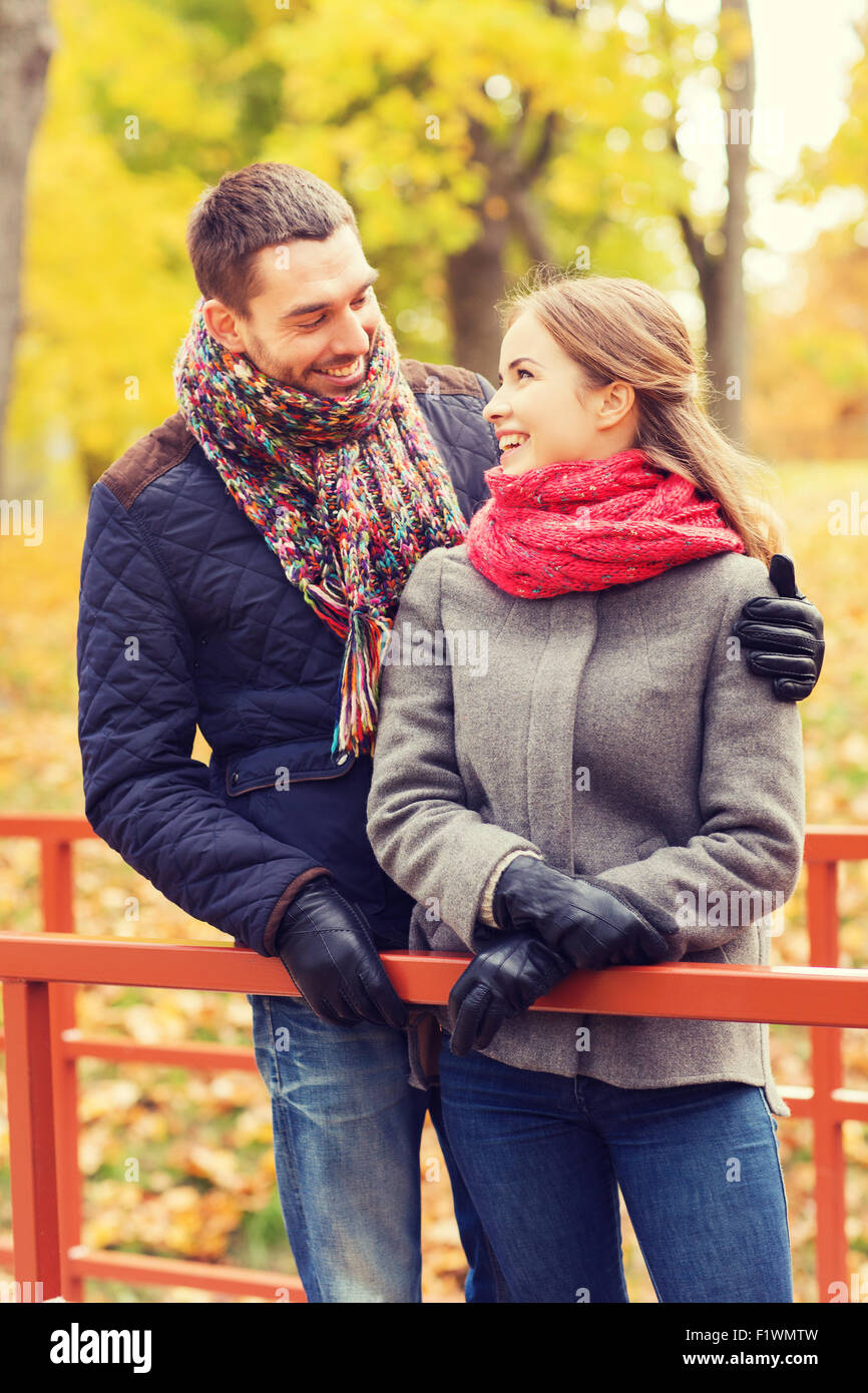 smiling couple hugging on bridge in autumn park Stock Photo - Alamy