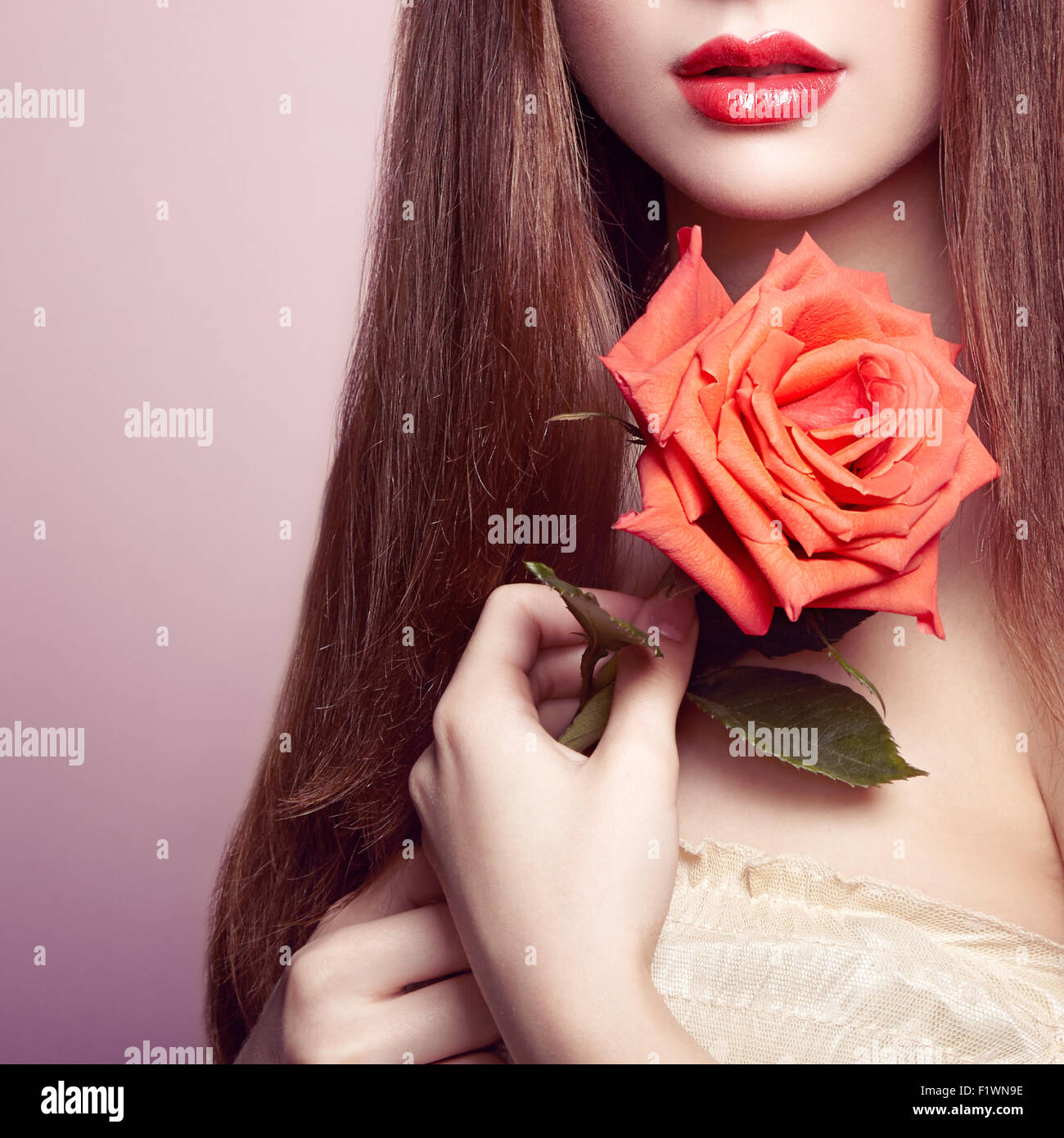Portrait of beautiful dark-haired woman with flowers. Perfect makeup. Brunette girl. Fashion photo Stock Photo
