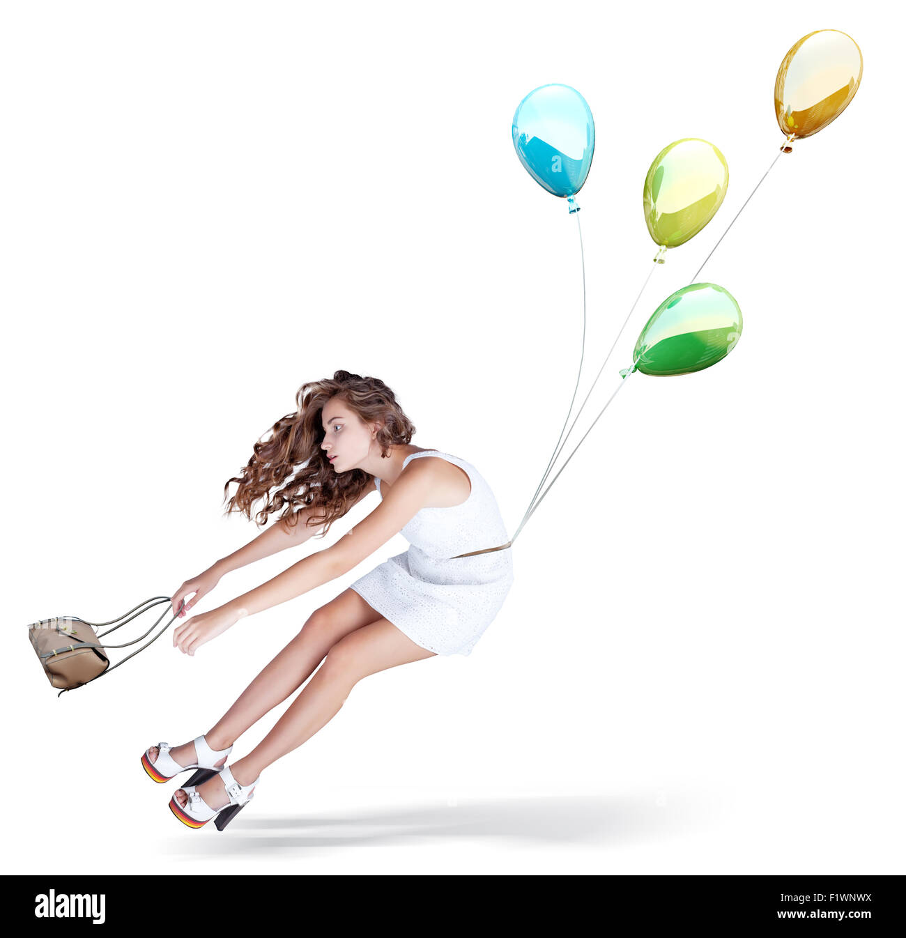 Balloons fly with young beautiful girl. Isolated Creative concept Stock Photo