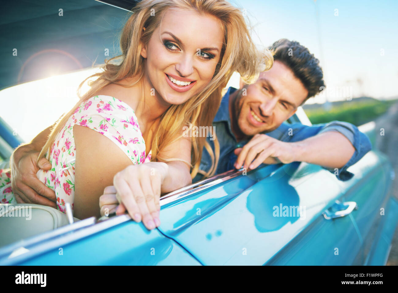 Smiling young couple resting in the retro car Stock Photo - Alamy