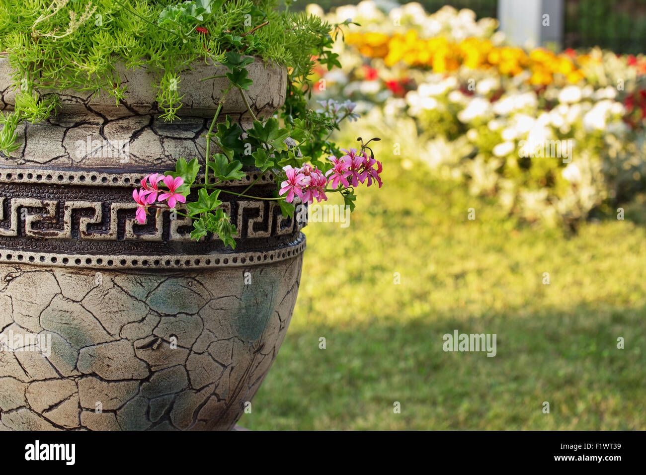 Greece vase with flowers on the natural background. Stock Photo