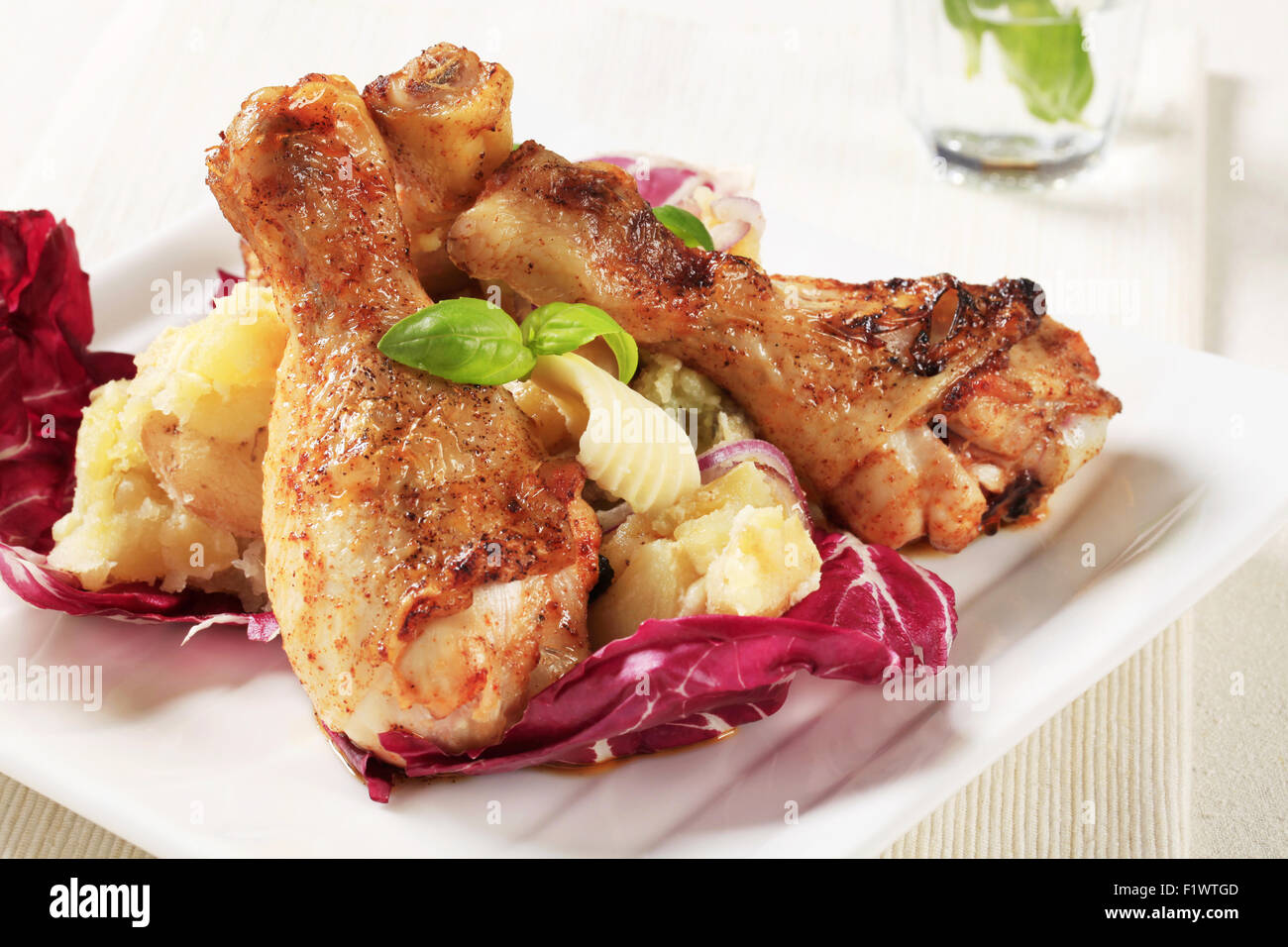 Roasted chicken drumsticks and crushed potatoes Stock Photo Alamy