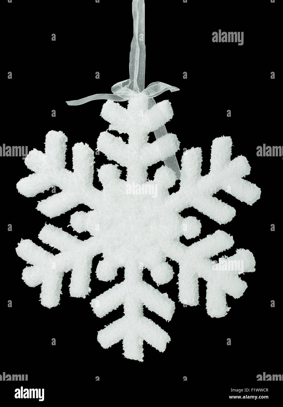 White snowflake on a black background. Stock Photo