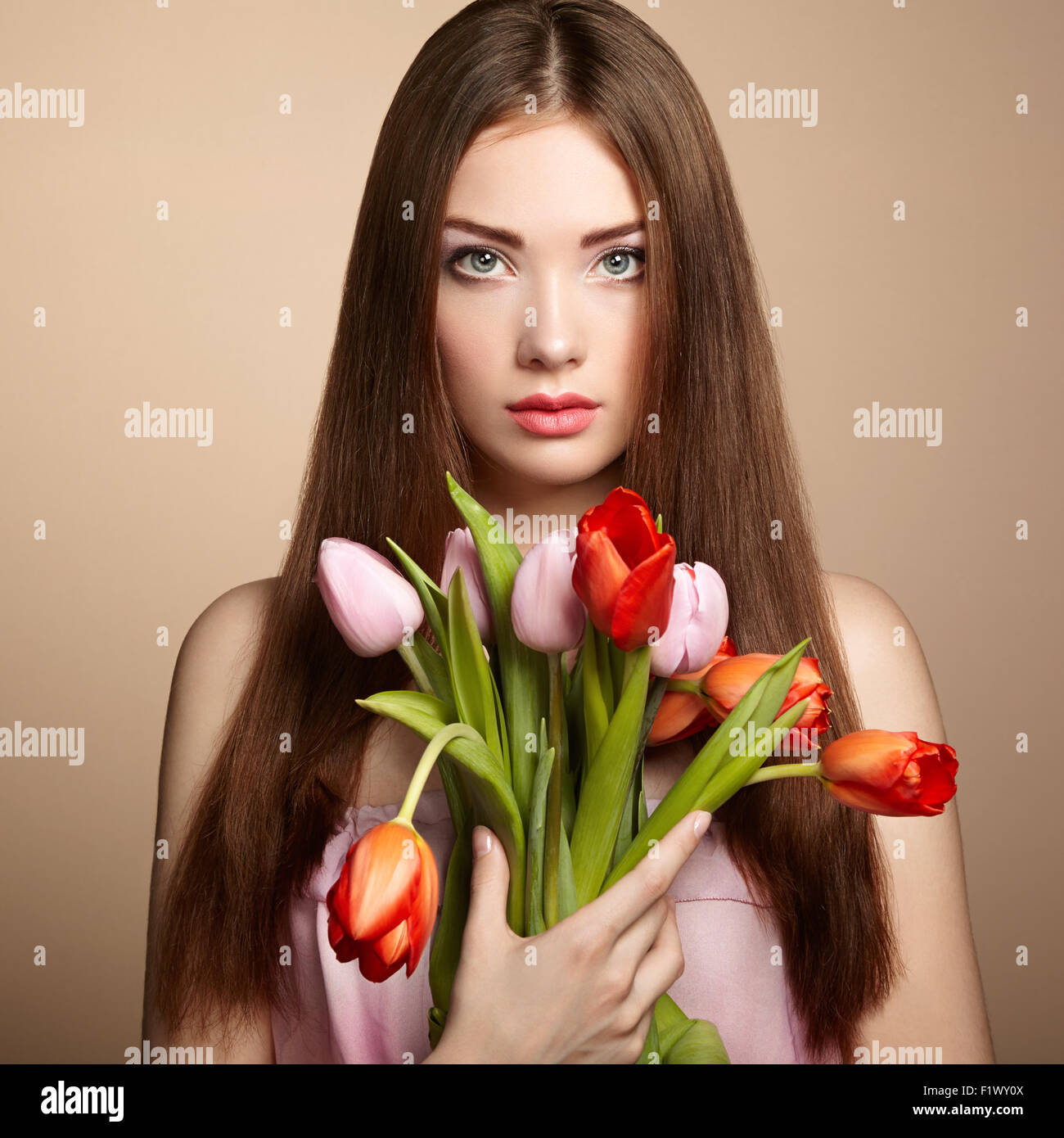 Portrait of beautiful dark-haired woman with flowers. Fashion photo Stock Photo