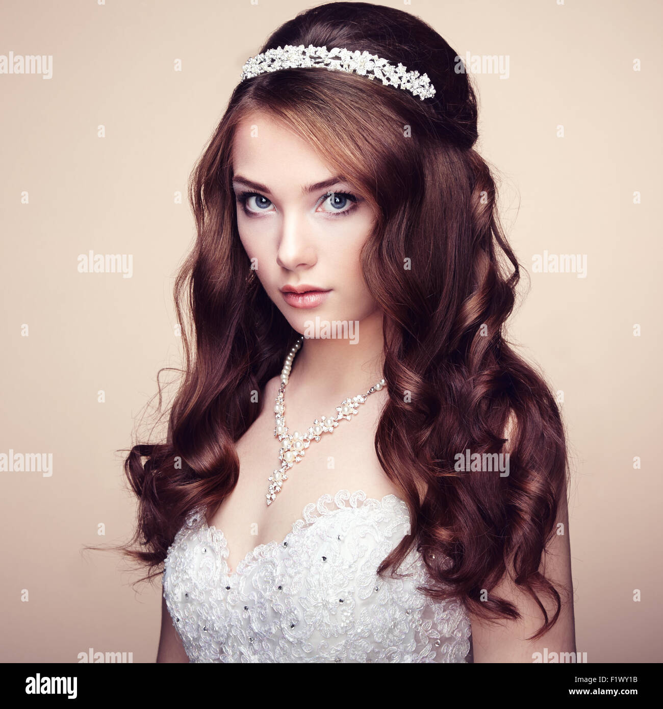 Portrait of beautiful sensual woman with elegant hairstyle. Wedding dress. Fashion photo Stock Photo