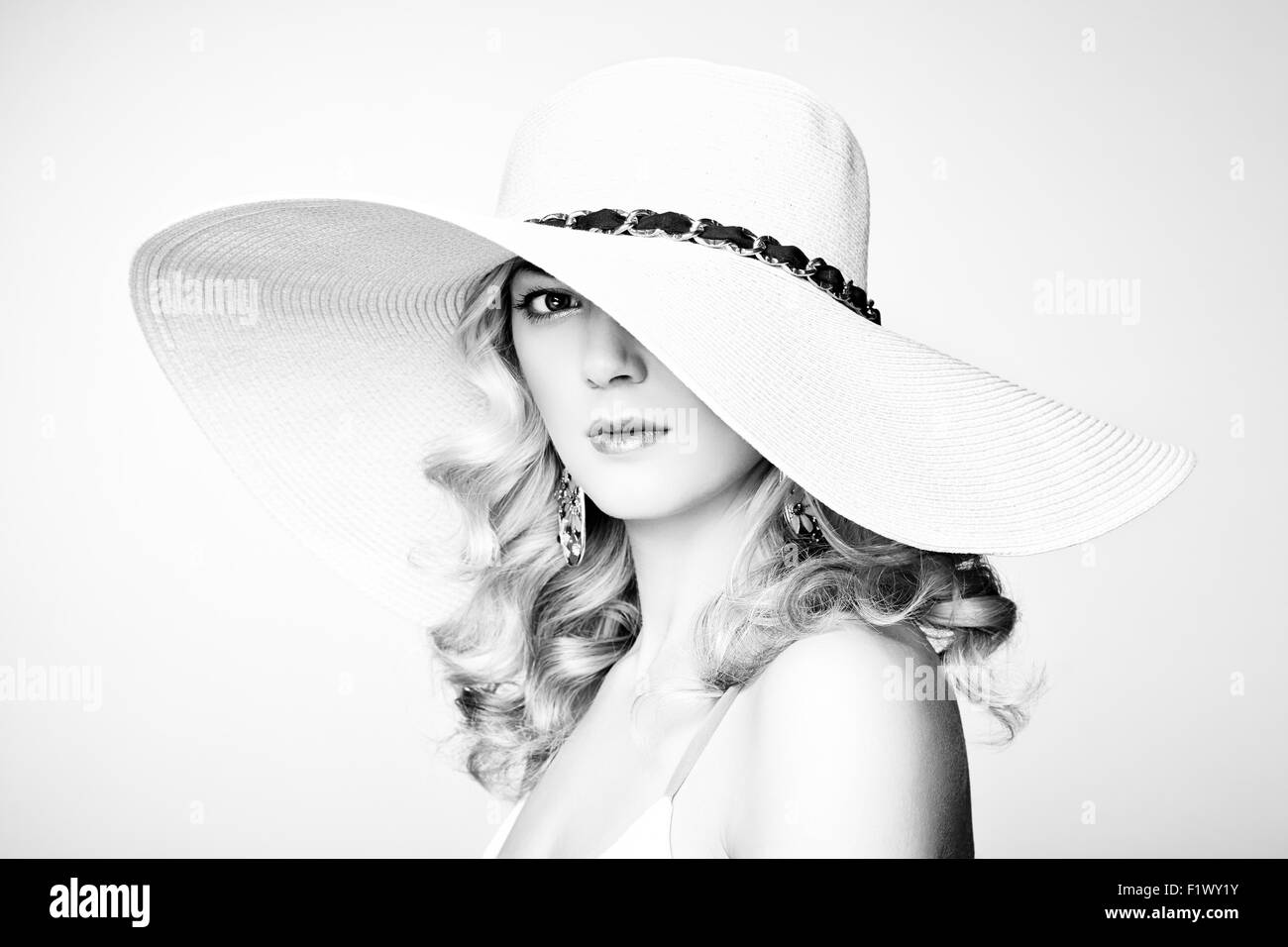 Fashion photo of young magnificent woman in hat. Girl posing. Studio photo. Blonde woman. Perfect Makeup Stock Photo