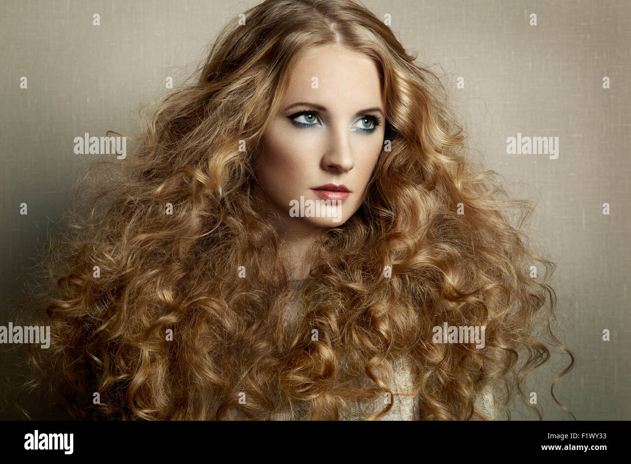 Portrait young beautiful woman with curly hair. Fashion photo Stock ...