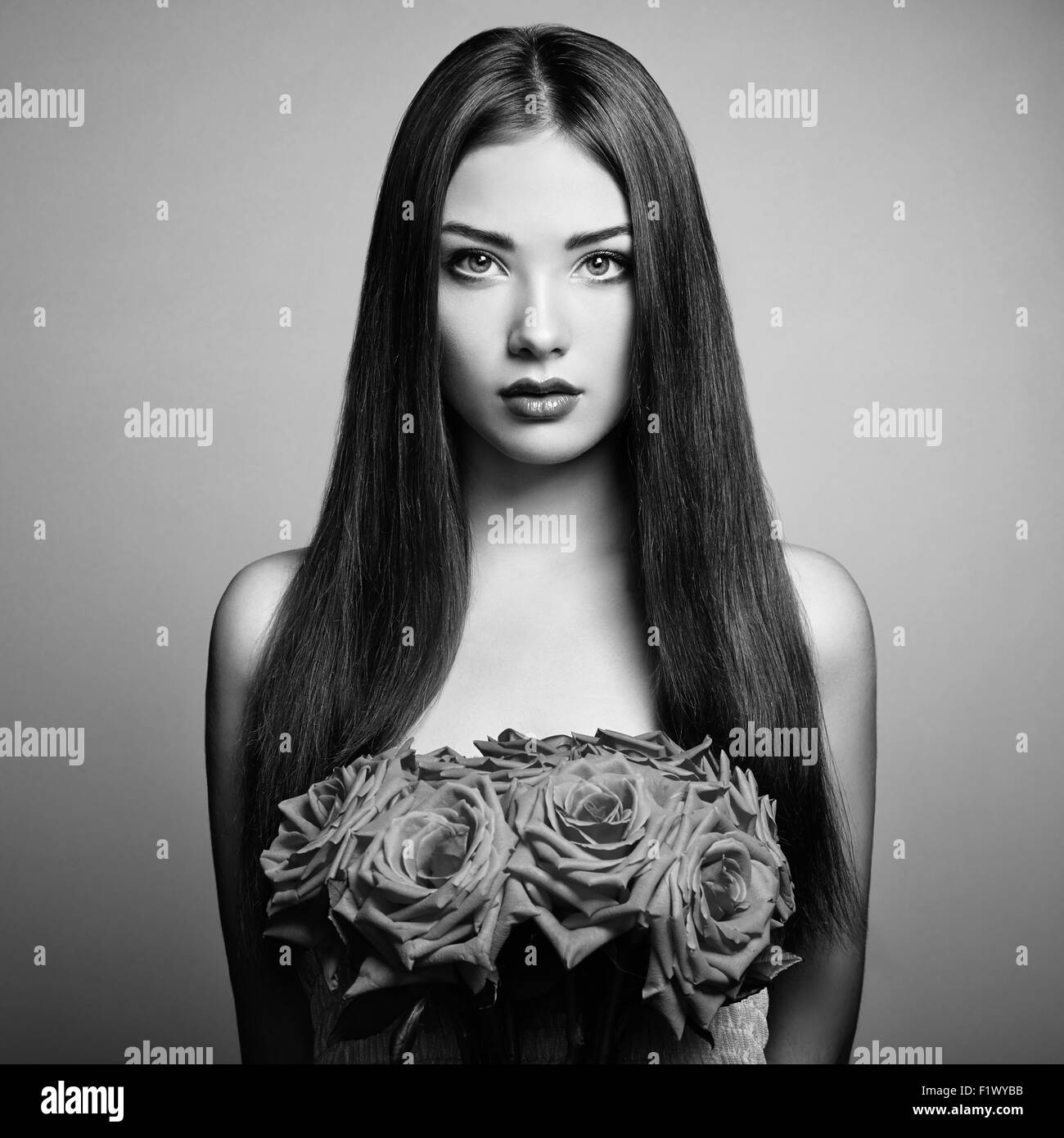 Portrait of beautiful dark-haired woman with flowers. Black and White photo Stock Photo