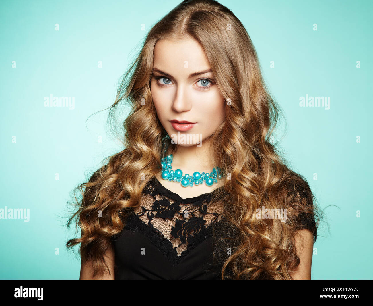Portrait of beautiful young blonde girl in black dress. Fashion photo ...