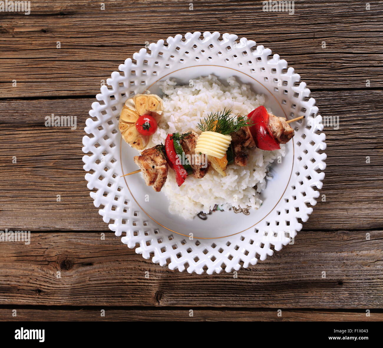 Chicken shish kebab on bed of white rice Stock Photo