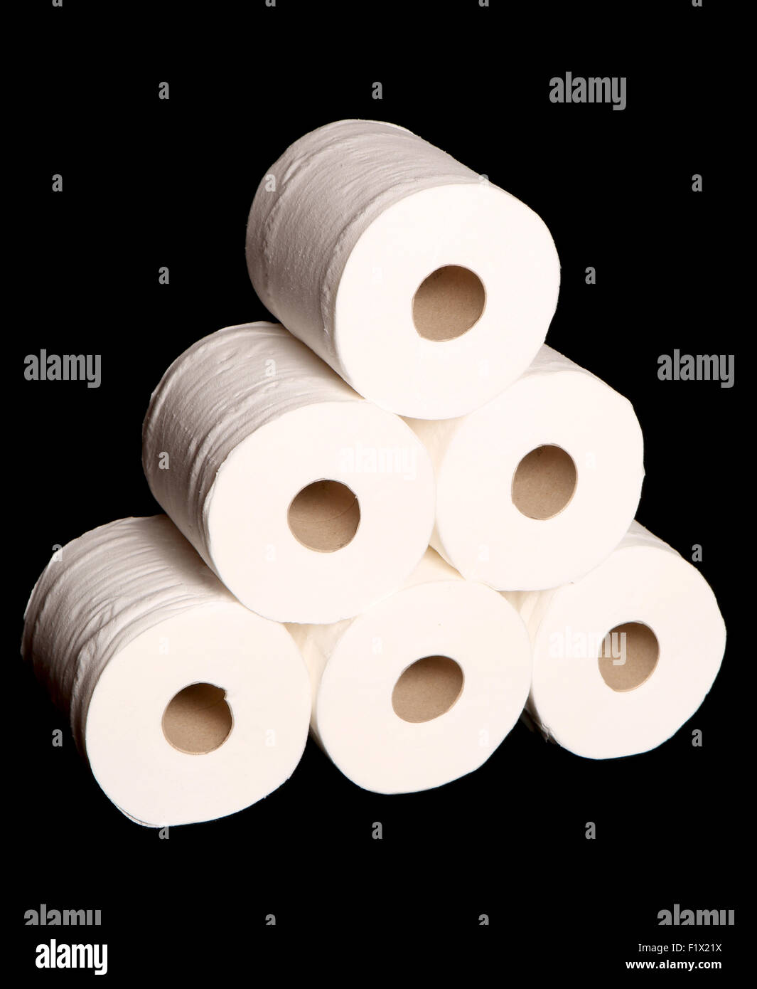 stack of toilet paper rolls on black background Stock Photo