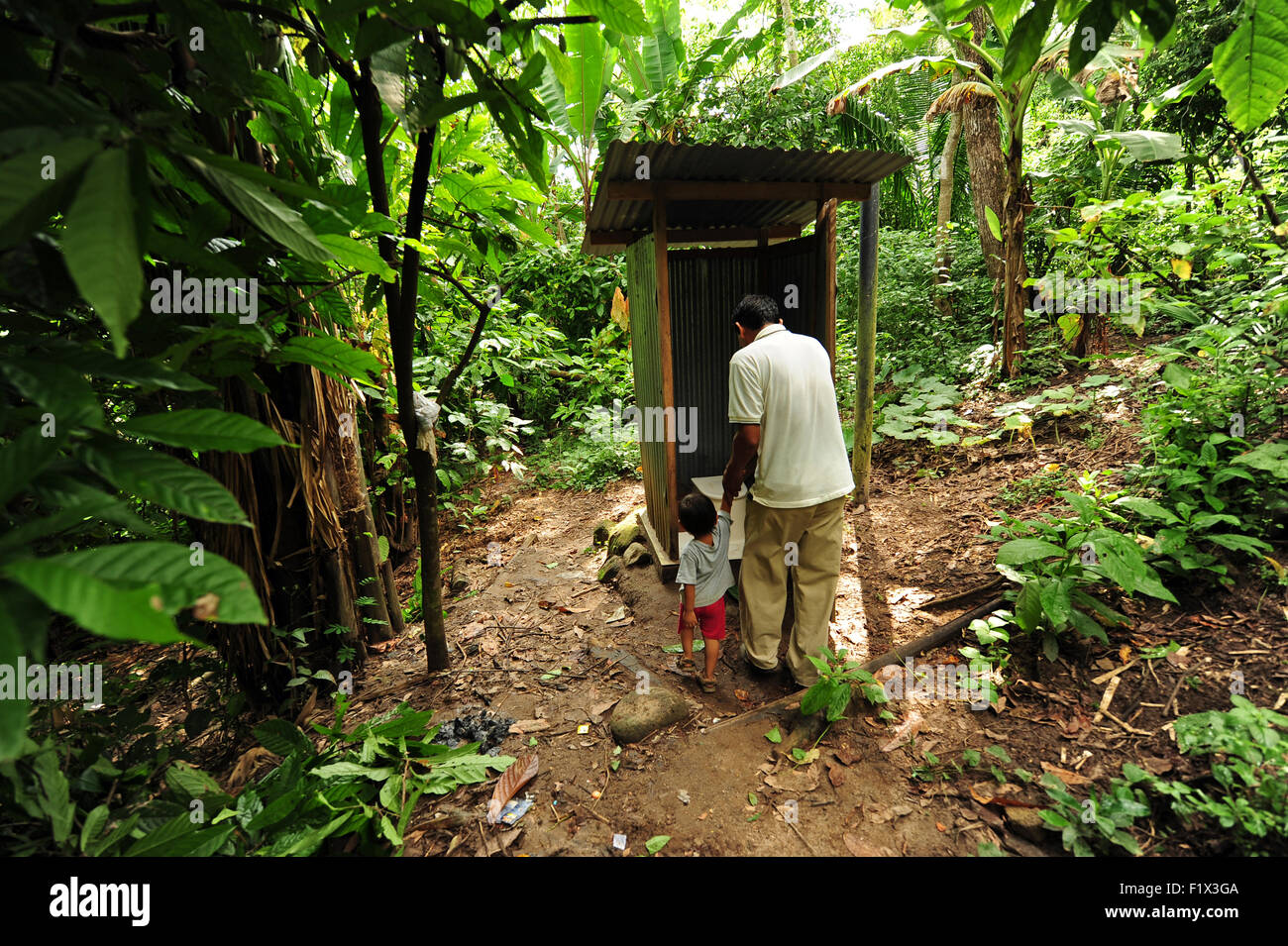 Guatemala, Retalhuleu, father going with son to latrine (Agustin Duenas 40 years; Javier Dueñas Lopez 3) Stock Photo