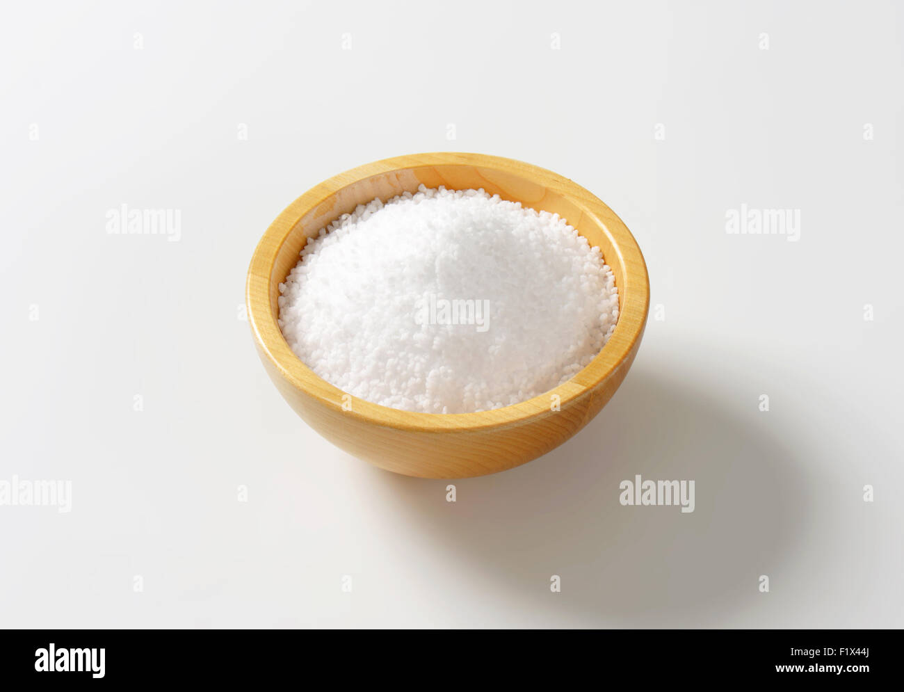 portion of grained salt in the wooden bowl Stock Photo