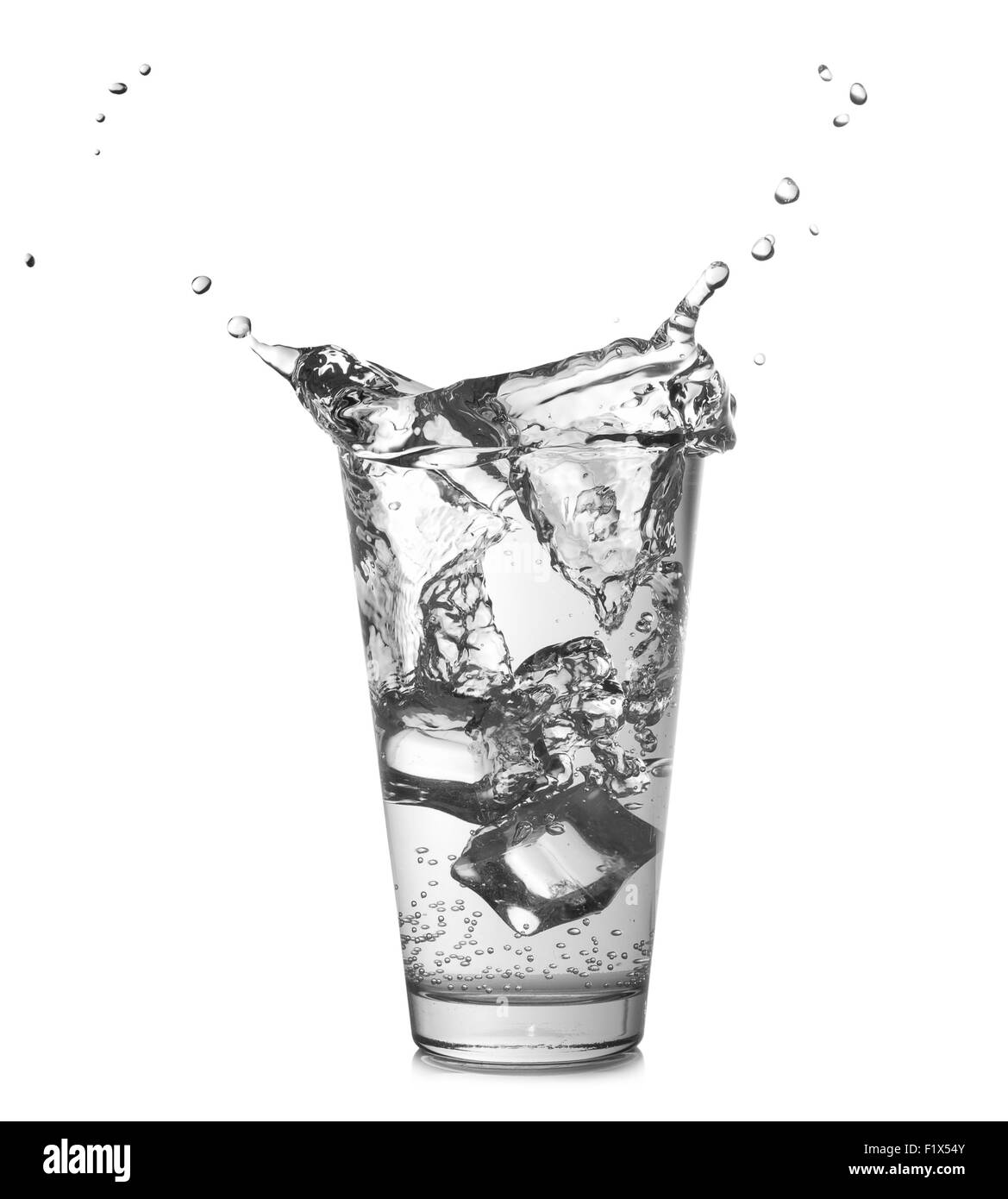 Falling ice in glass of water  on the white background. Stock Photo