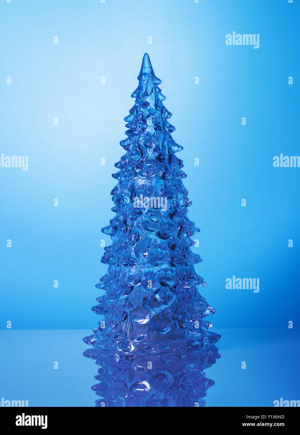 Crystal Christmas tree on blue background. Stock Photo