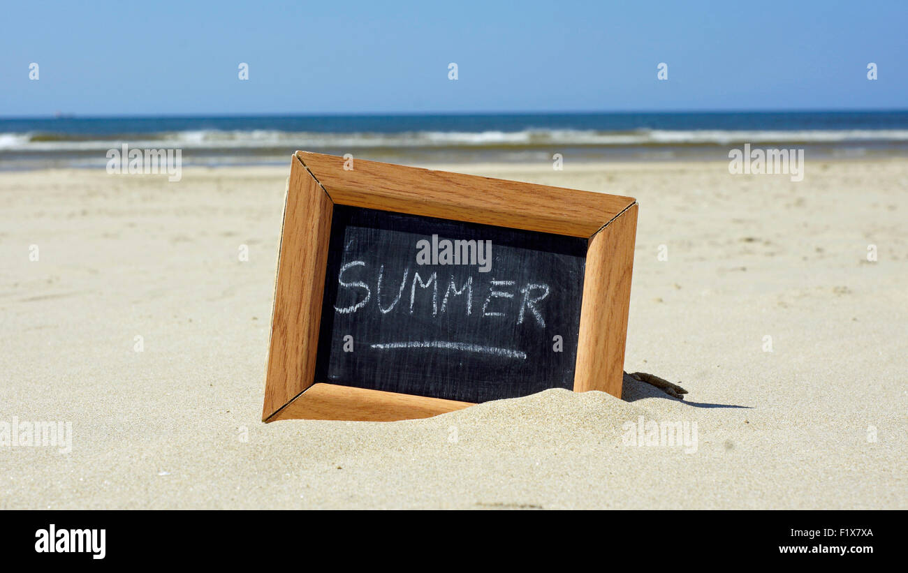 Summer written on a chalkboard at the beach Stock Photo - Alamy
