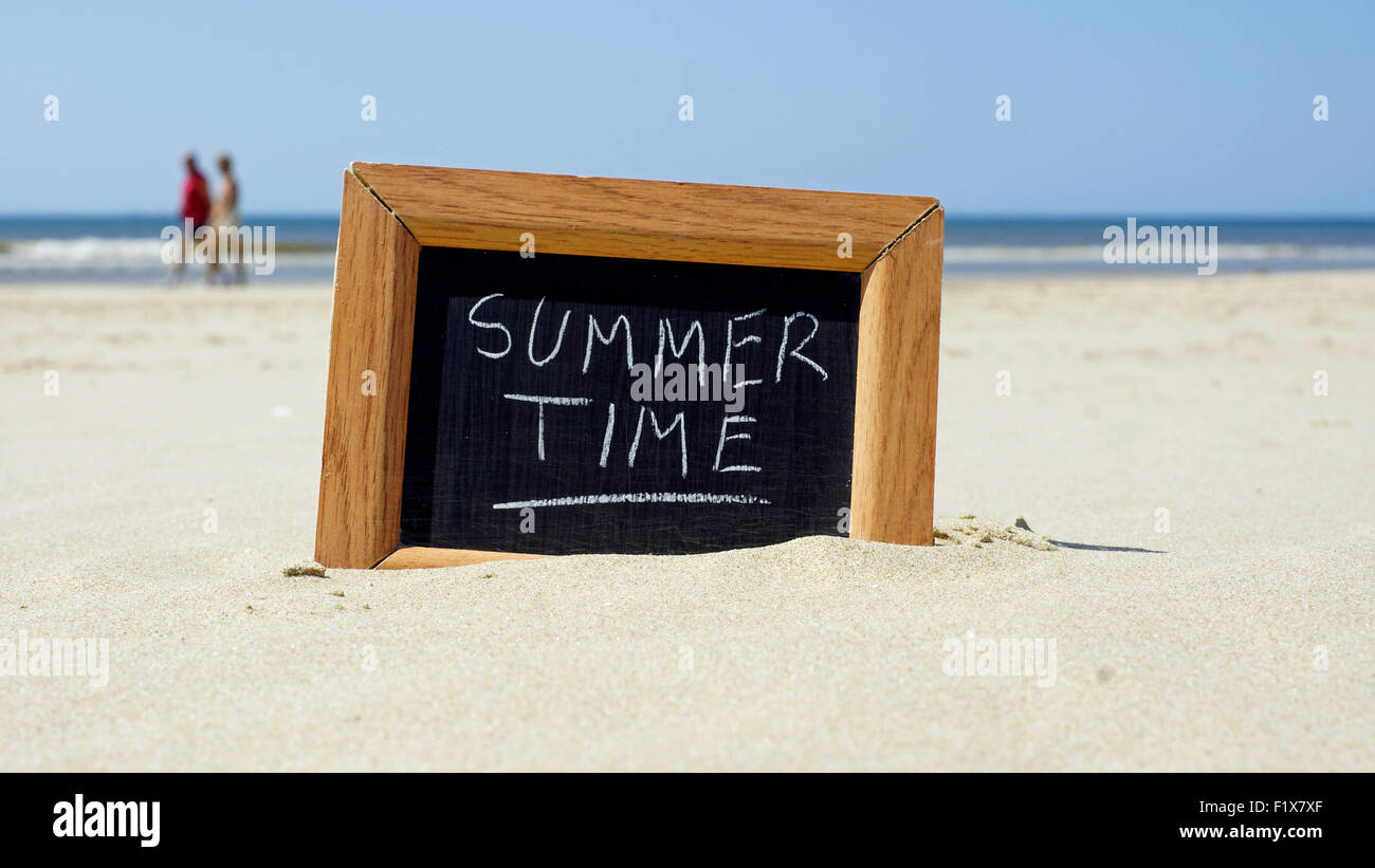 Summertime written on a chalkboard at the beach Stock Photo - Alamy