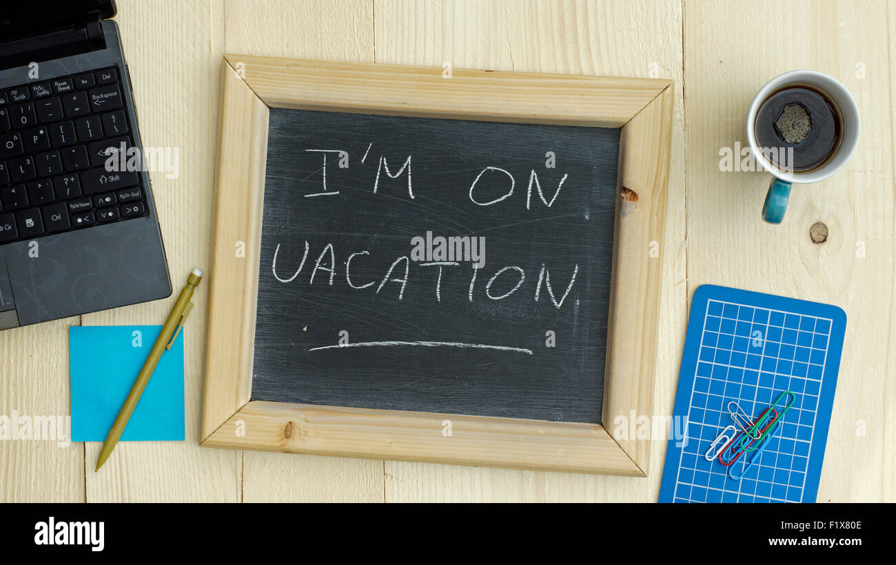 I'm on vacation written on a chalkboard at the office Stock Photo - Alamy