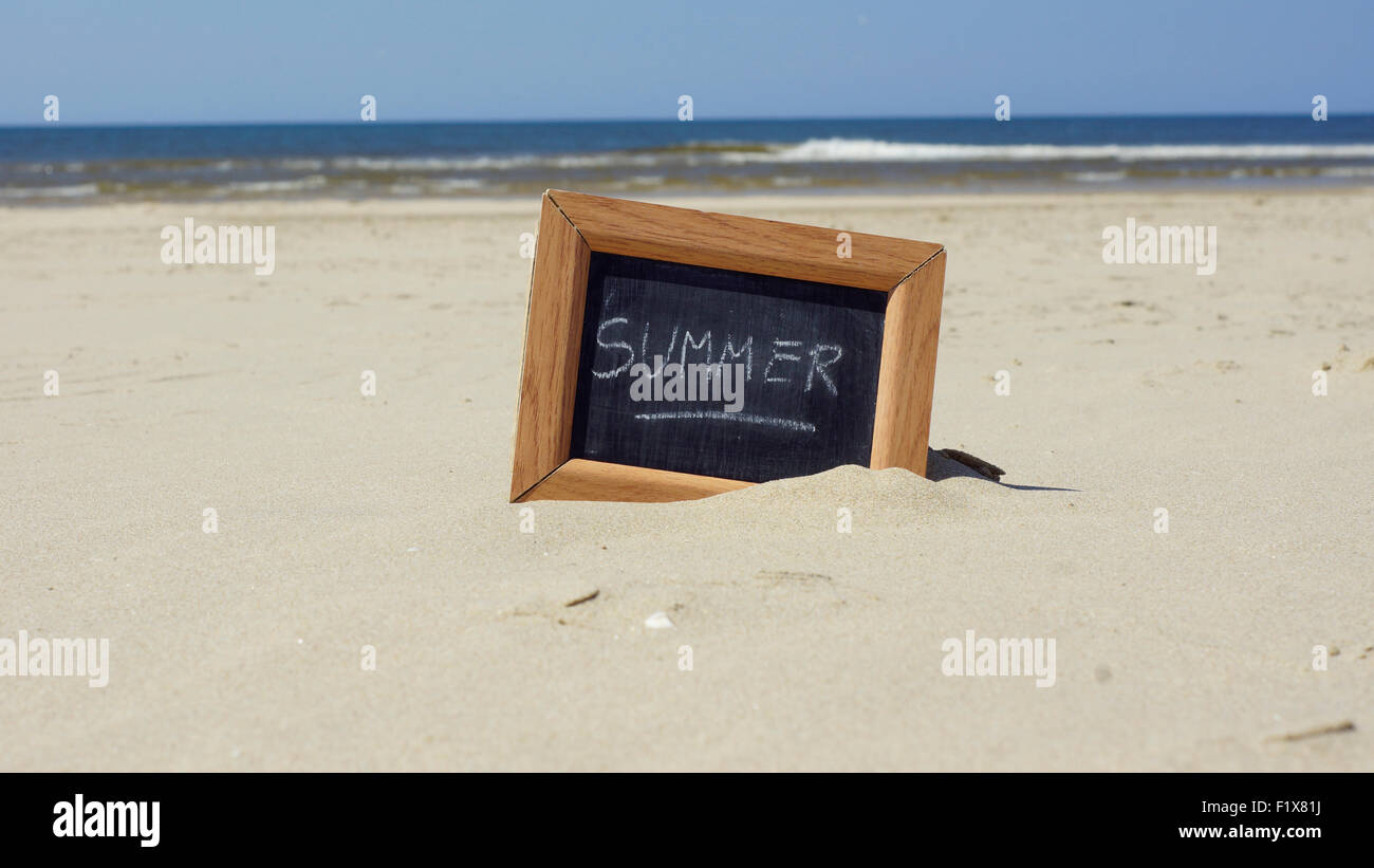 Summer written on a chalkboard at the beach Stock Photo - Alamy