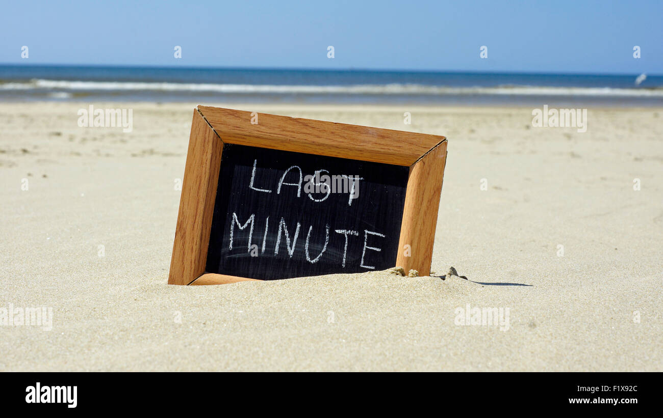 Last minute written on a chalkboard at the beach Stock Photo - Alamy
