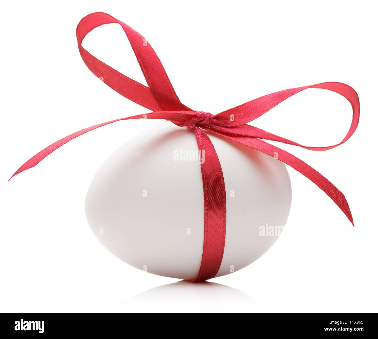 Easter egg with festive red bow isolated on white background. Stock Photo