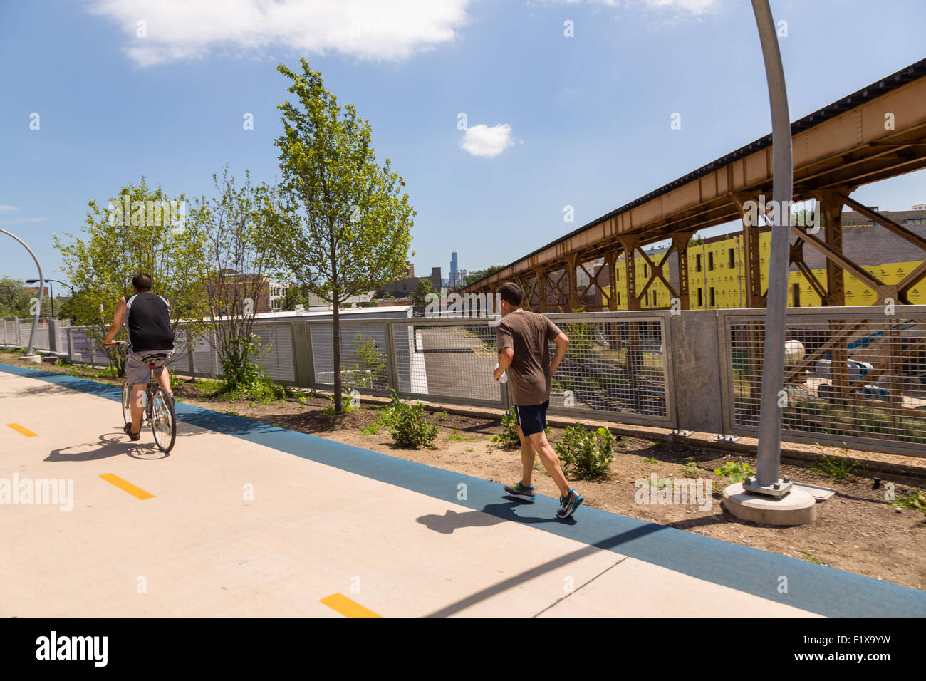 Runners at Milwaukee Avenue along the 606 elevated bike trail, green space and park built on the old Bloomingdale Line in the Wicker Park neighborhood in Chicago, Illinois, USA Stock Photo