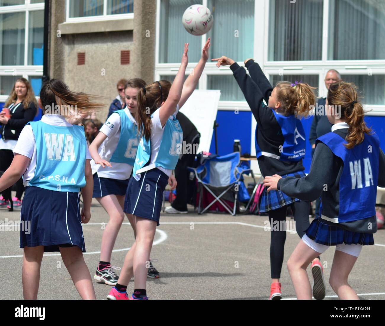 Girls play netball outside Stock Photo