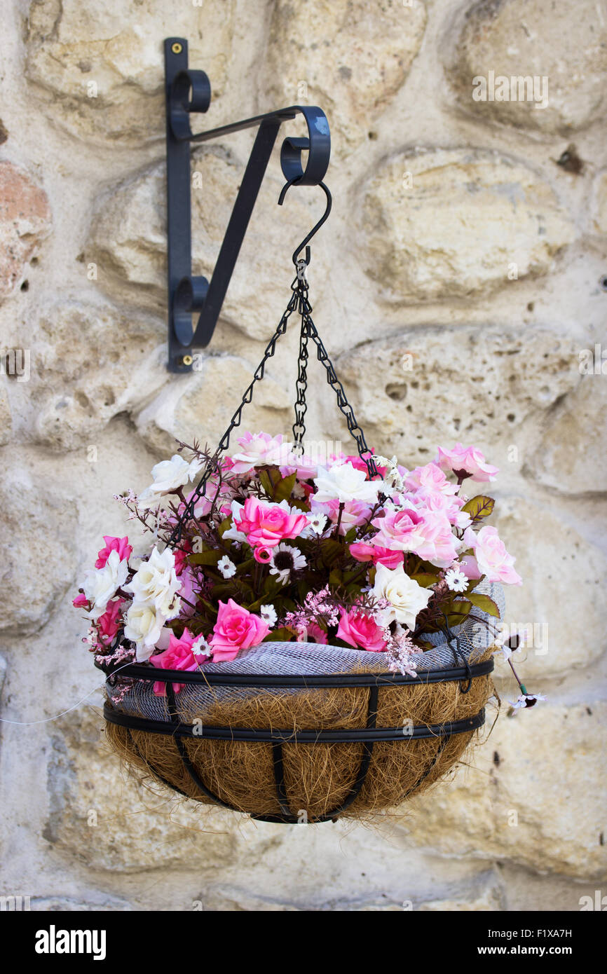 beautiful flowers in the big pot on the wall . Stock Photo