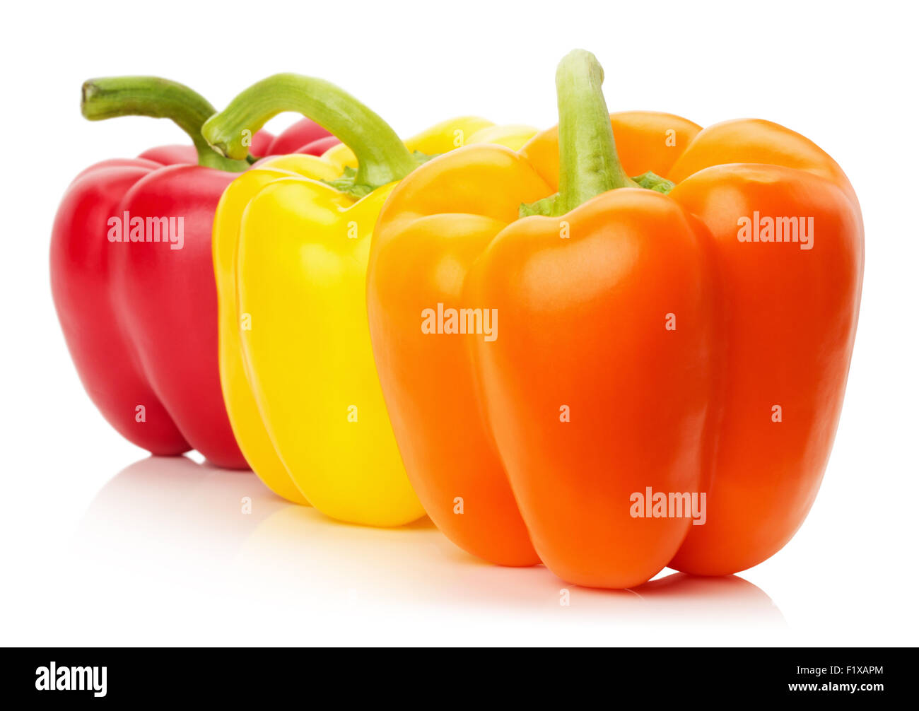 red, yellow and orange peppers isolated on the white background. Stock Photo