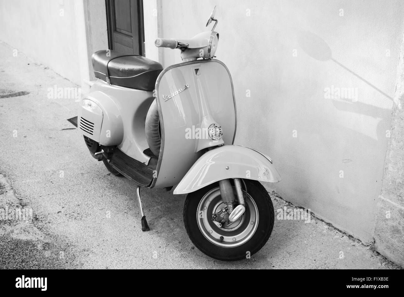 Gaeta, Italy - August 19, 2015: Classic Vespa scooter stands parked near wall Stock Photo