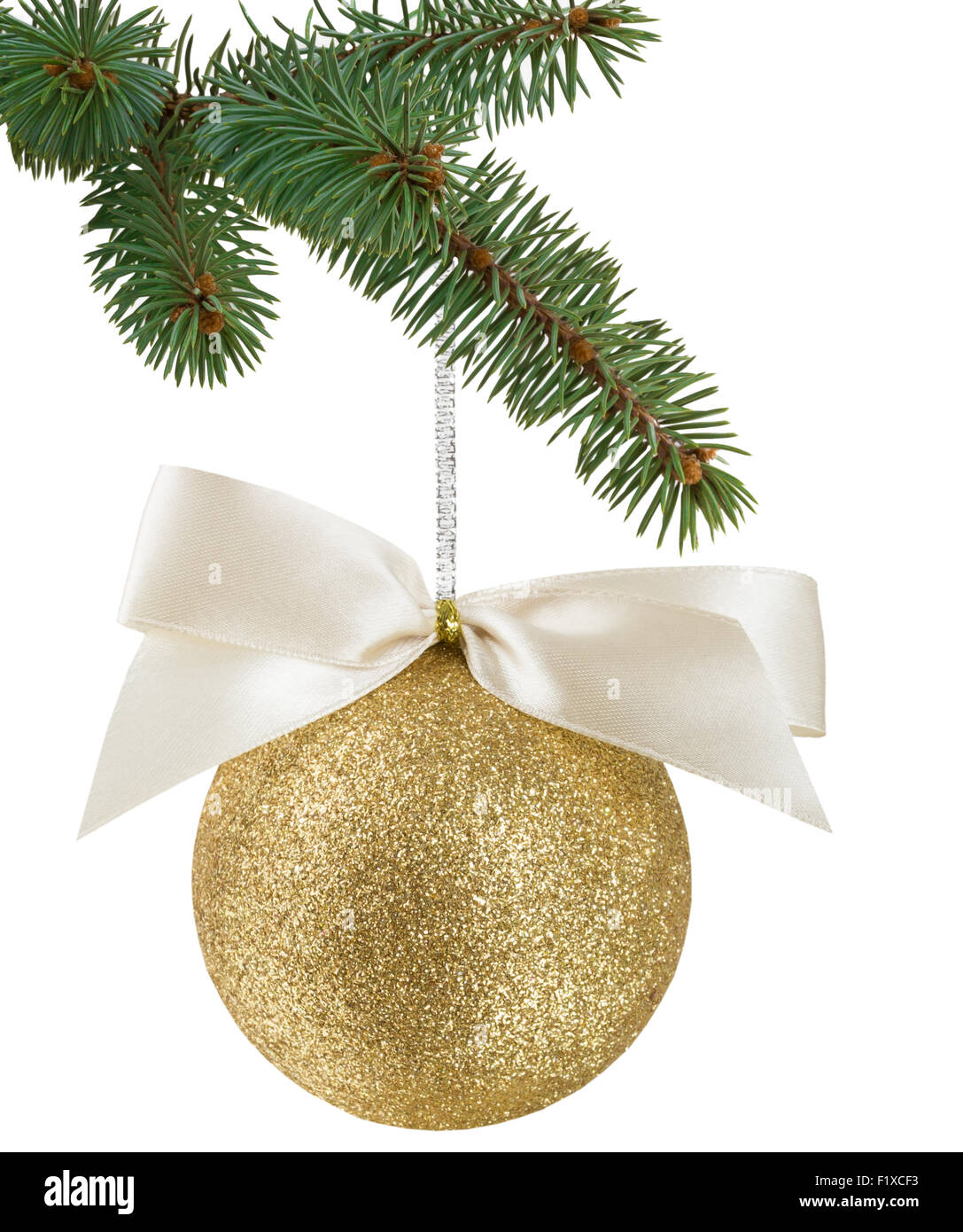 Christmas tree branch with a gold Christmas ball with ribbon. Stock Photo