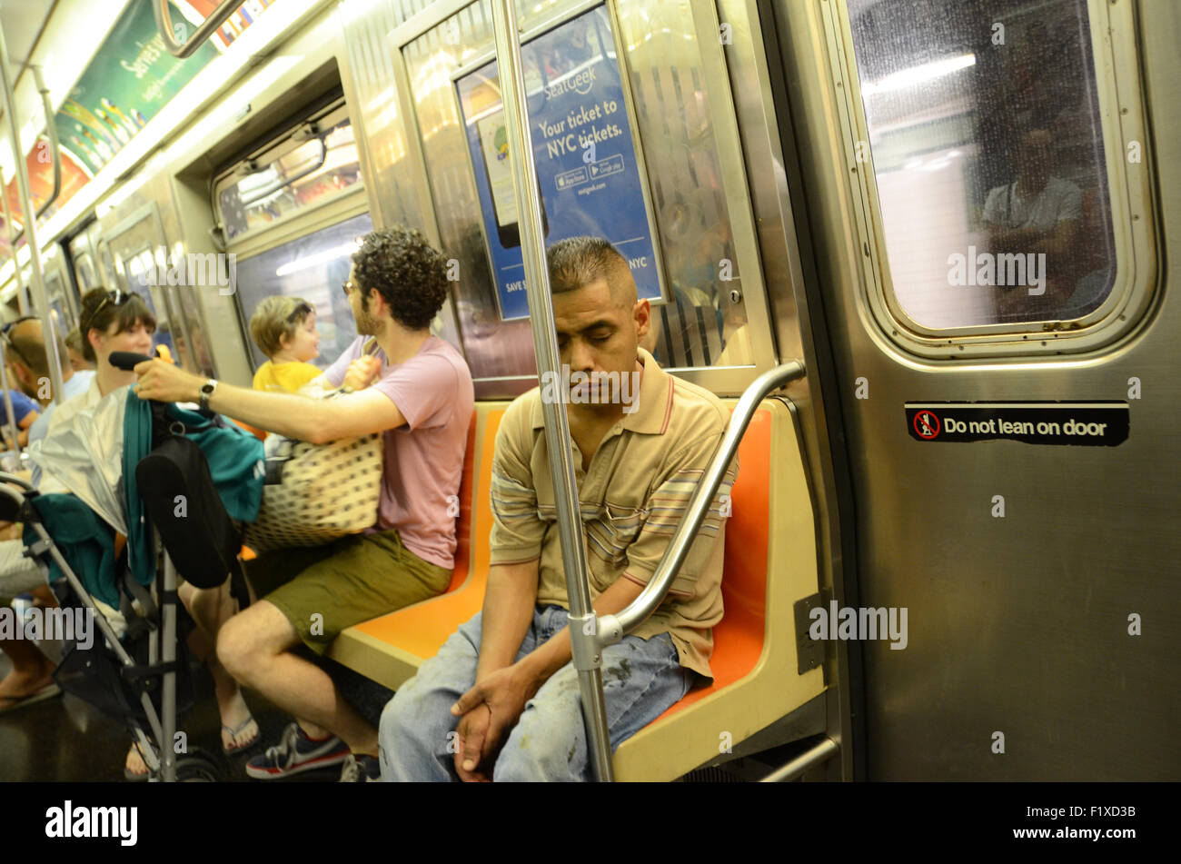 man asleep on subway new york Stock Photo - Alamy