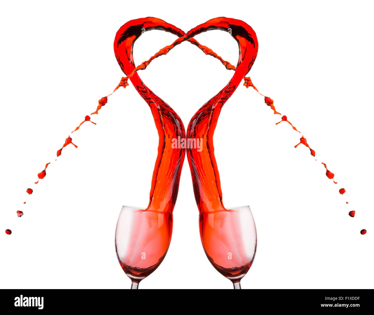 Red wine spilling and forming heart shape. Stock Photo