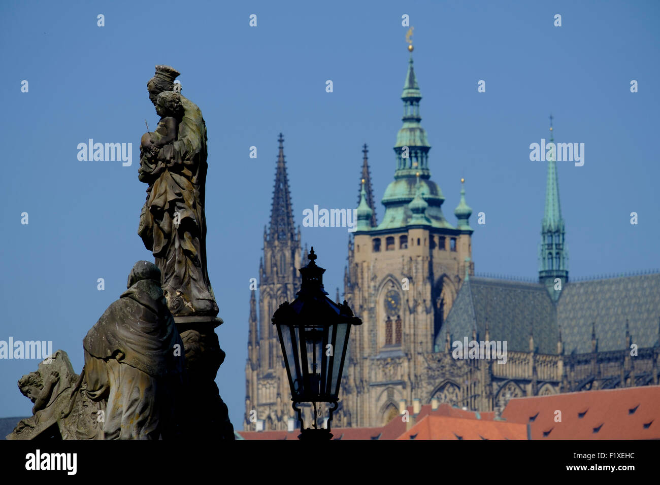 Statue on the Charles Bridge with the St. Vitus cathedral in the background, Prague, Czech Republic, Europe Stock Photo