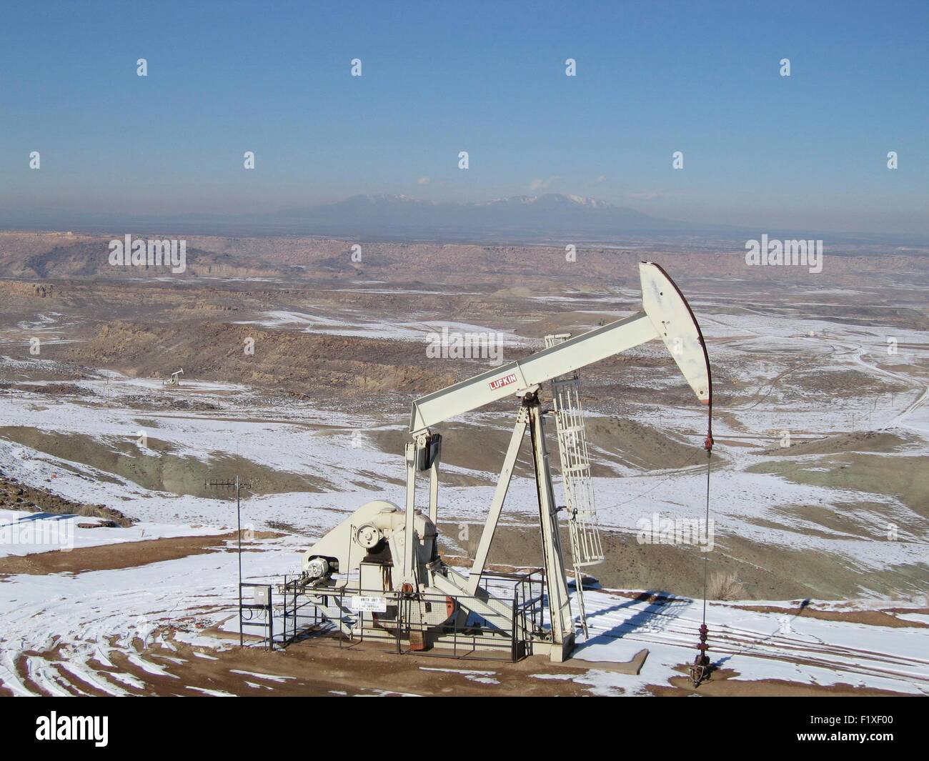 An oil pump jack pulling crude out of the ground in North Dakota Stock