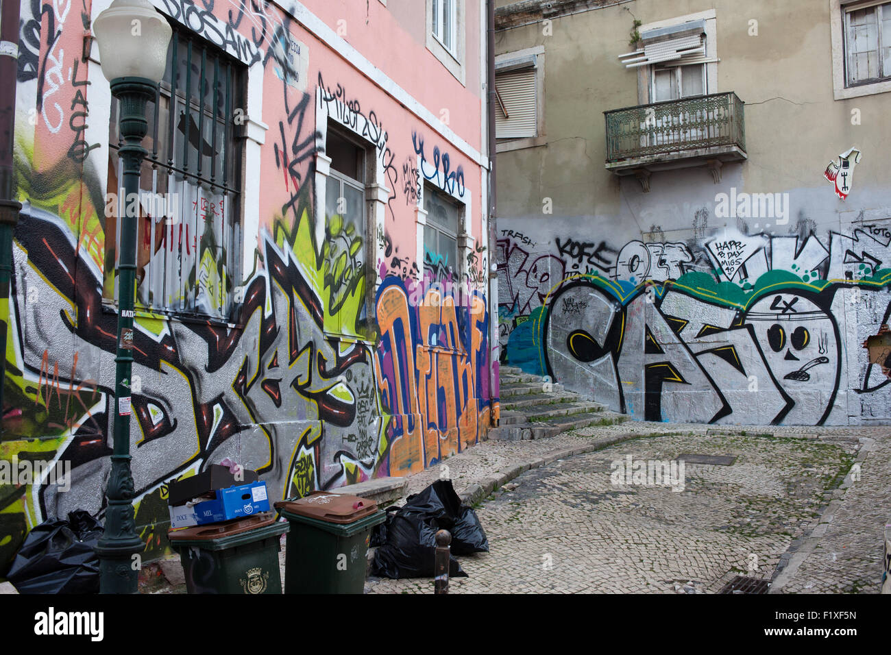 Graffiti on building wall and garbage on backyard in Lisbon, Portugal Stock Photo