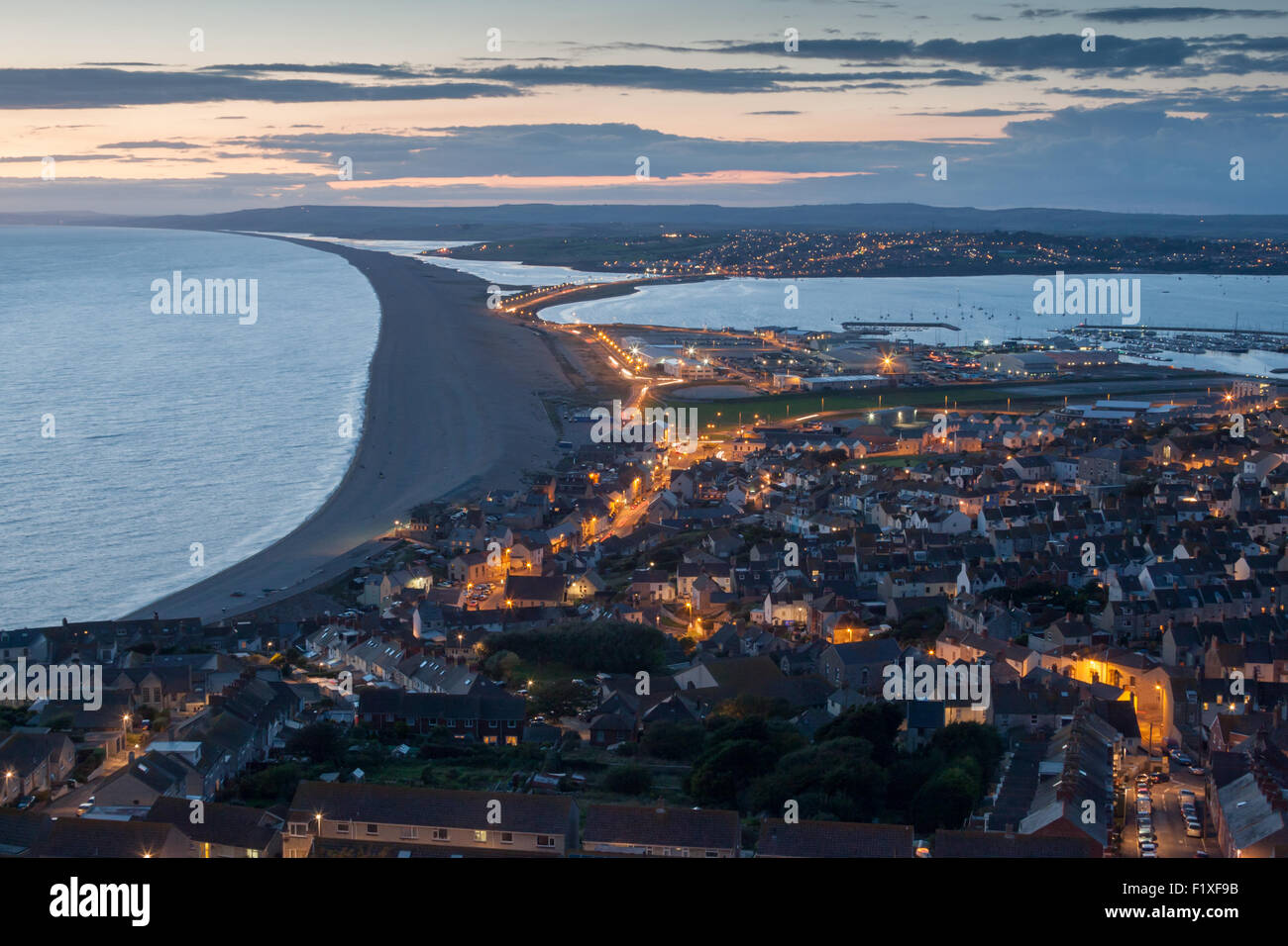 Evening view over Chesil Beach and Weymouth after sunset, Dorset UK, taken from Portland. Stock Photo