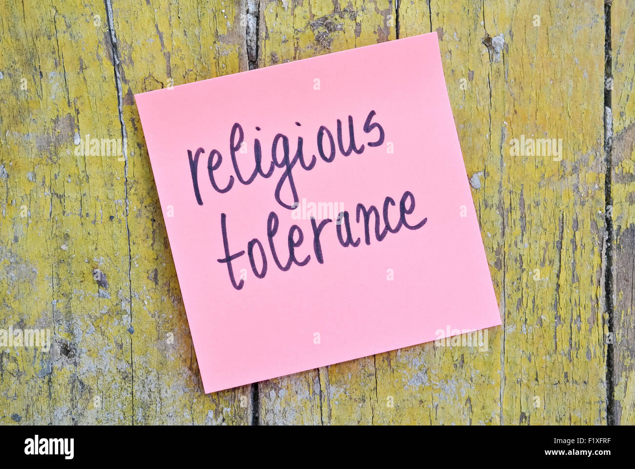 Pink sticker with words Religious Tolerance on wooden background Stock Photo