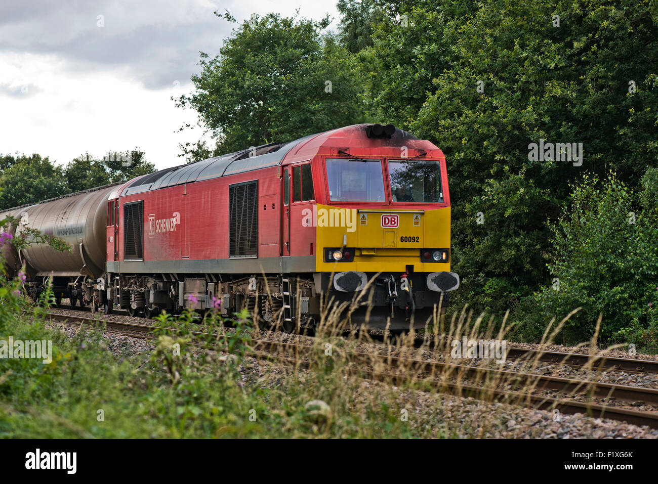 DB Schenker 60092 train on railway line next to the Whisby Nature Park, Near Lincoln, Lincolnshire, UK Stock Photo