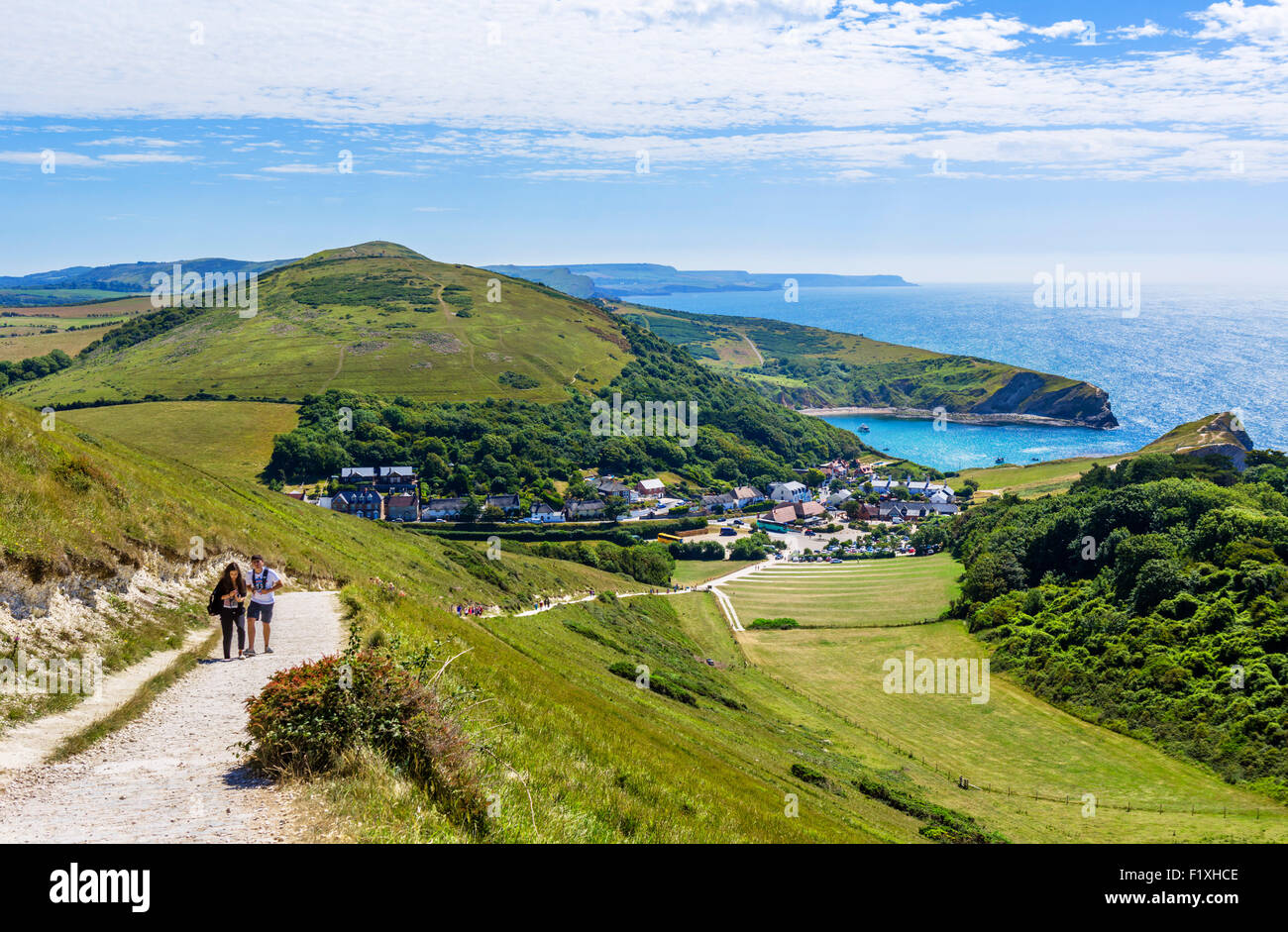 Walkers on the South West Coast Path overlooking Lulworth Cove, Lulworth, Jurassic Coast, Dorset, England, UK Stock Photo