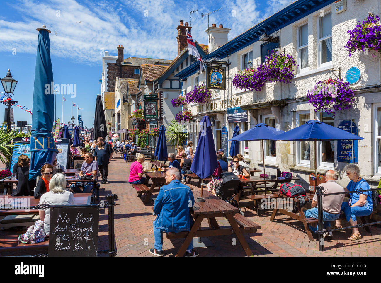 People sitting outside The Lord Nelson pub on The Quay in Poole, Dorset, England, UK Stock Photo
