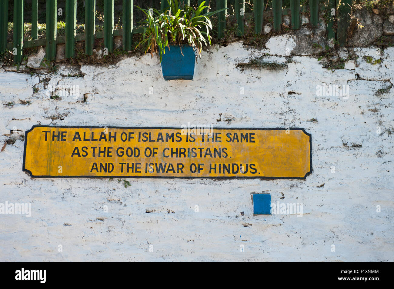Shimla, Himachal Pradesh, India. The Toy Train railway sign: 'The Allah of Islam is the same as God of Christians and the Iswar of Hindus.' Stock Photo