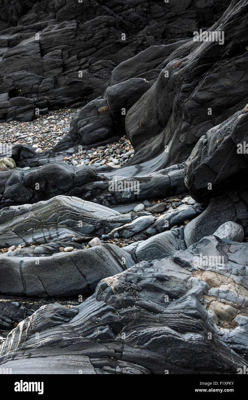 Contours of smooth, worn rocks on the beach at Trefin in Pembrokeshire, Wales. Stock Photo