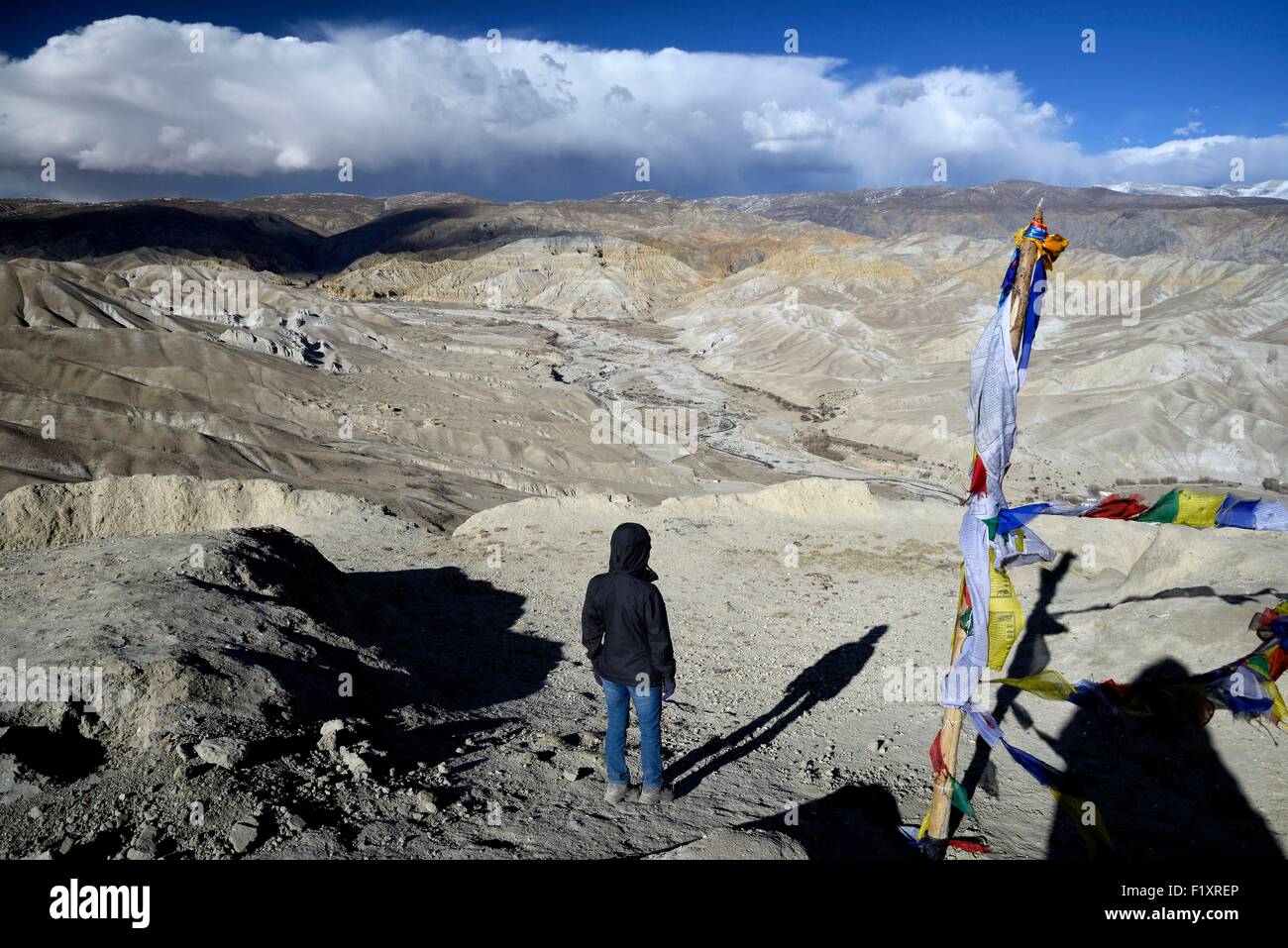 Nepal, Gandaki zone, Upper Mustang (near the border with Tibet), woman watching the landscape from the fort above Lo Manthang Stock Photo