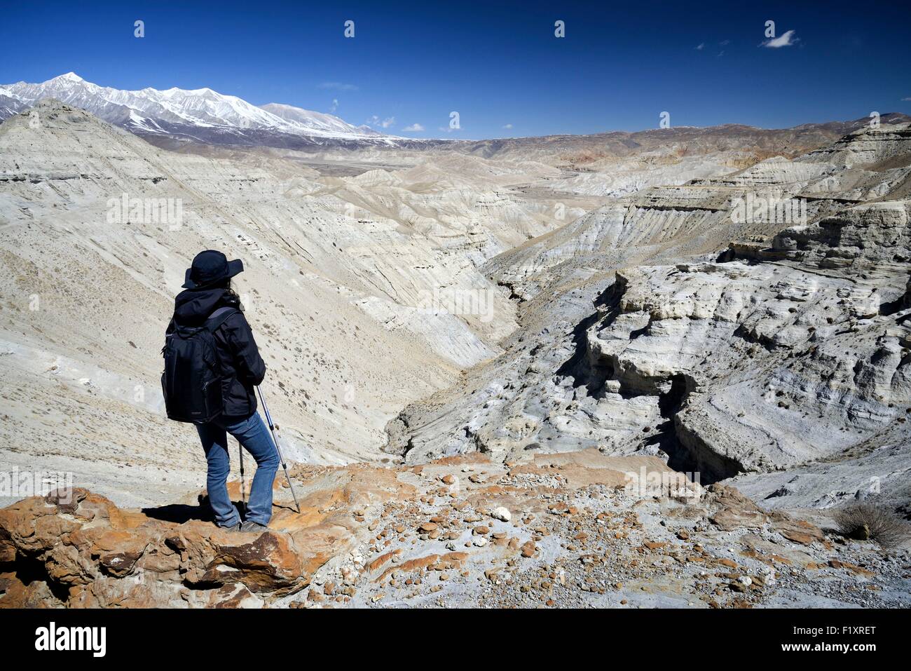 Nepal, Gandaki zone, Upper Mustang (near the border with Tibet), trekker and mineral landscape between Lo Manthang and the village of Dhie Gaon Stock Photo