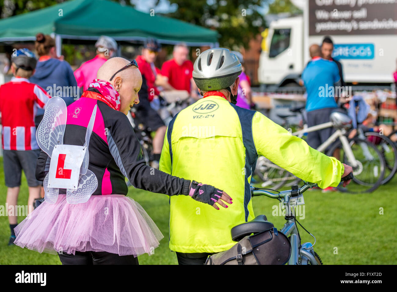 A lady dressed as a fairy walking with her father after the 20k bike ride at The Carvers sponsored Wolverhampton Marathon 2015 Stock Photo