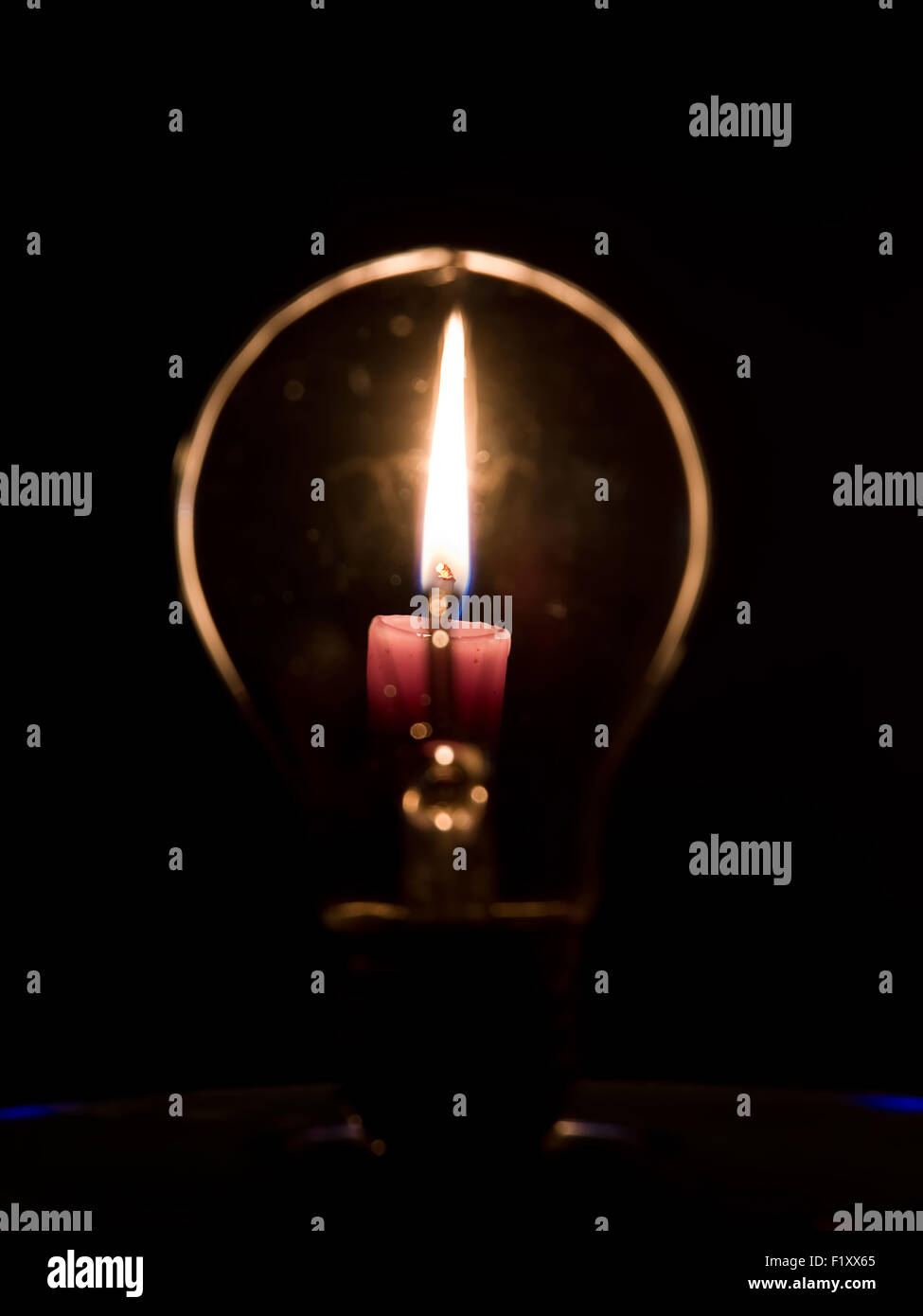 Lightbulb and candle flame Stock Photo Alamy