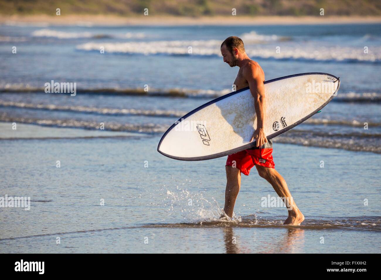 Costa Rica, Guanacaste province, Nicoya Peninsula, near Tamarindo, Playa Grande, surfer Stock Photo