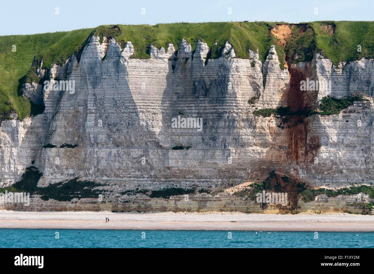 France, Seine Maritime, Pays de Caux, Cote d'Albatre, Fecamp, two people on the beach at the foot of cliffs Stock Photo
